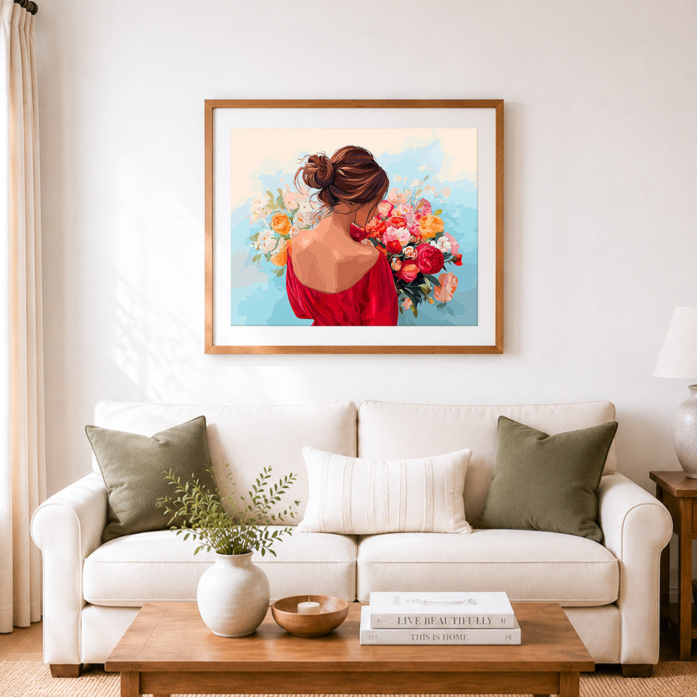 Finished woman holding fresh bouquet cross stitch artwork displayed as home decor