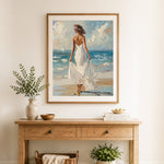 Finished woman in a white dress by the ocean cross stitch artwork displayed as home decor