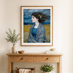 Finished woman in blue dress with gray shawl in field cross stitch artwork displayed as home decor