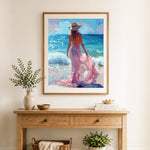 Finished woman in pink dress on beach cross stitch artwork displayed as home decor
