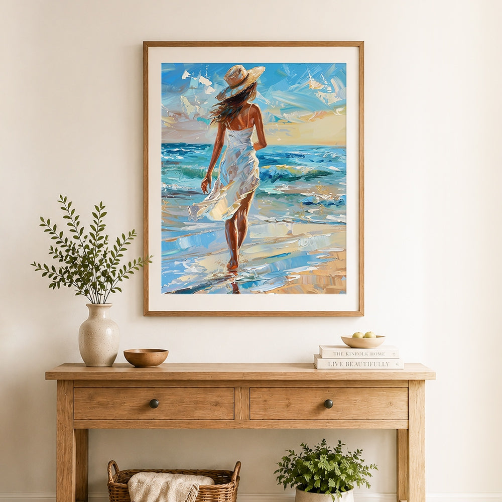 Finished woman in straw hat walking on beach cross stitch artwork displayed as home decor