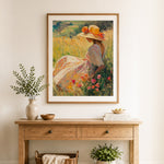 Finished woman in yellow dress under pink blossom tree cross stitch artwork displayed as home decor