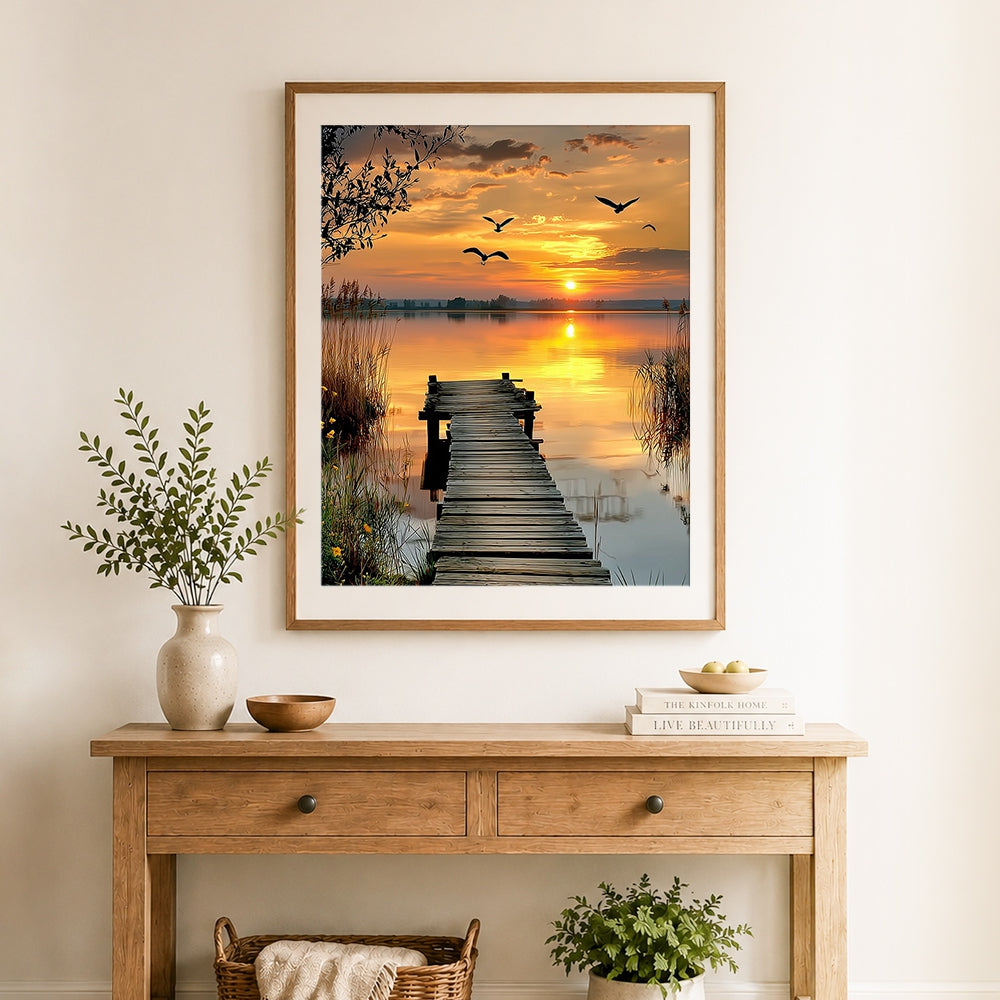Finished wooden pier at sunset sea with flying birds cross stitch artwork displayed as home decor
