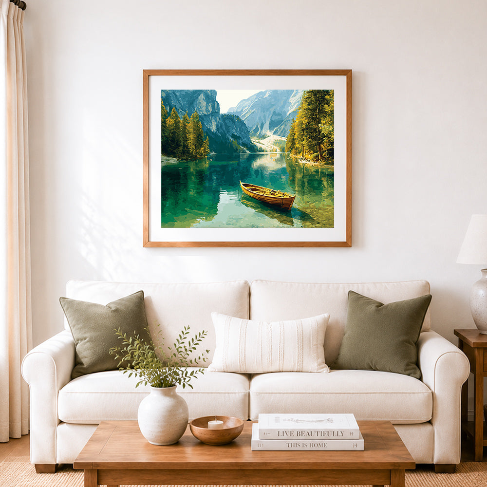 Finished wooden rowboat on mountain lake cross stitch artwork displayed as home decor
