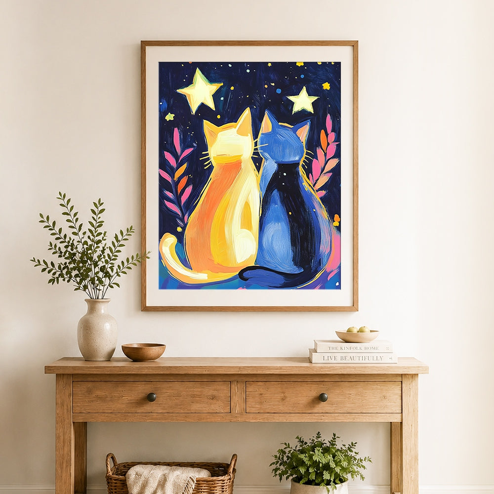 Finished yellow and blue cats under stars cross stitch artwork displayed as home decor