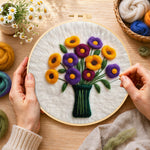 Creating the yellow and purple flowers in vase wool painting by hand with a felting needle