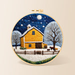 Yellow barn and white trees under the winter moon needle felting kit for beginners with a round wooden frame