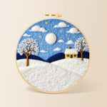 Yellow cottage in the snow needle felting kit for beginners with a round wooden frame