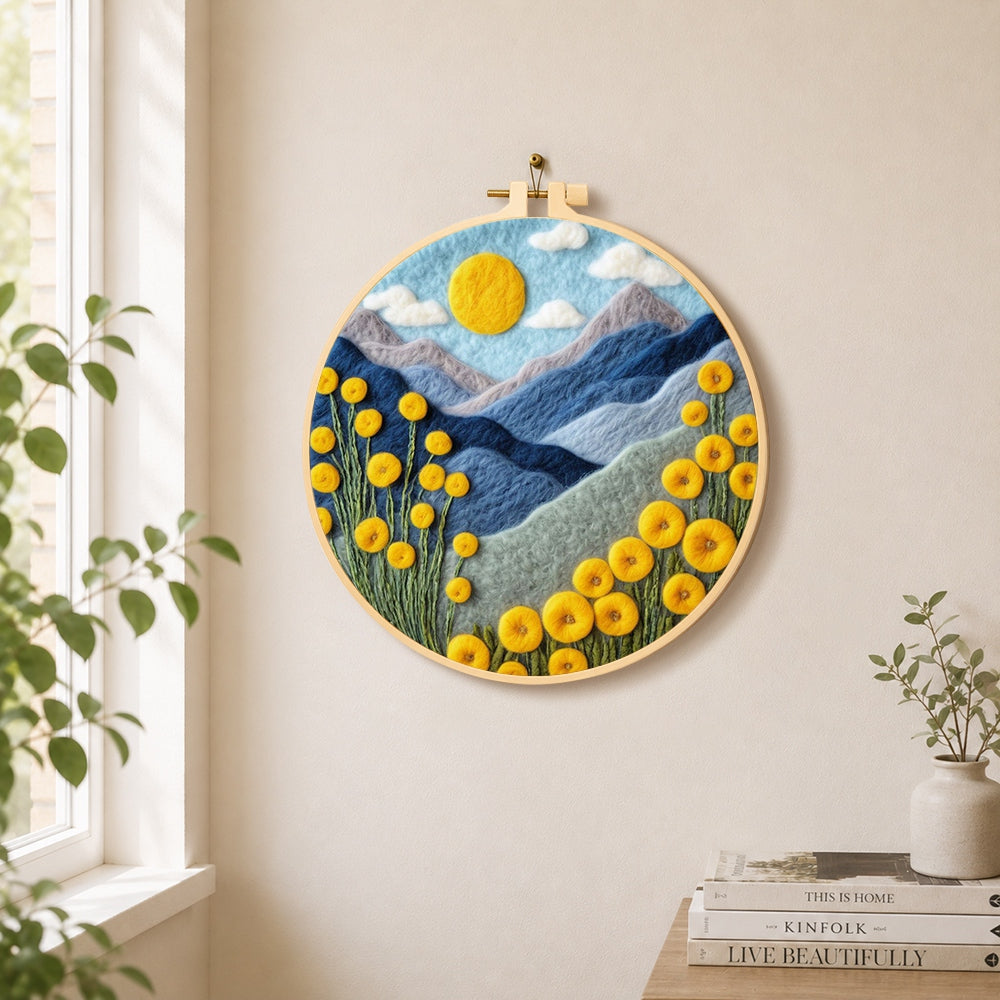 Yellow flowers and blue mountains needle felt wall art displayed in a bright home interior
