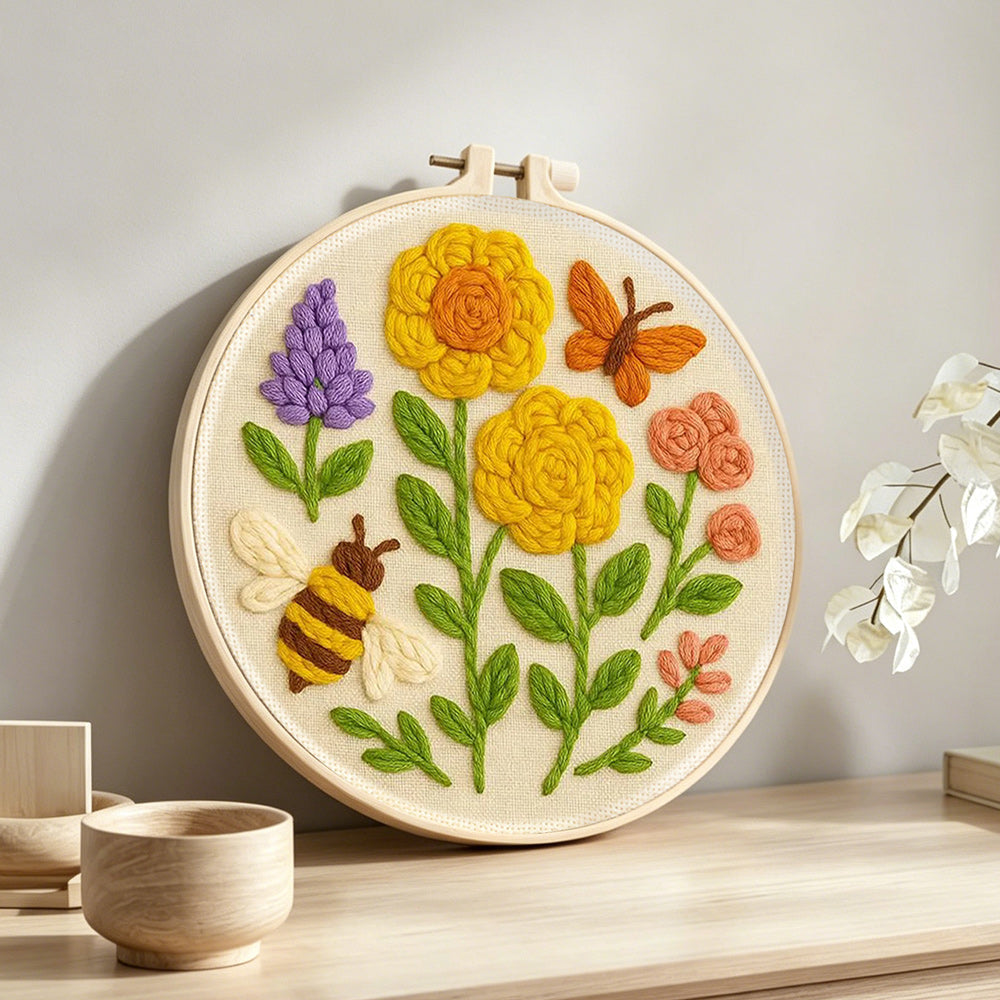 Yellow flowers, butterfly and bee punch needle artwork displayed on a table