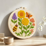 Yellow flowers, butterfly and bee punch needle artwork displayed on a table