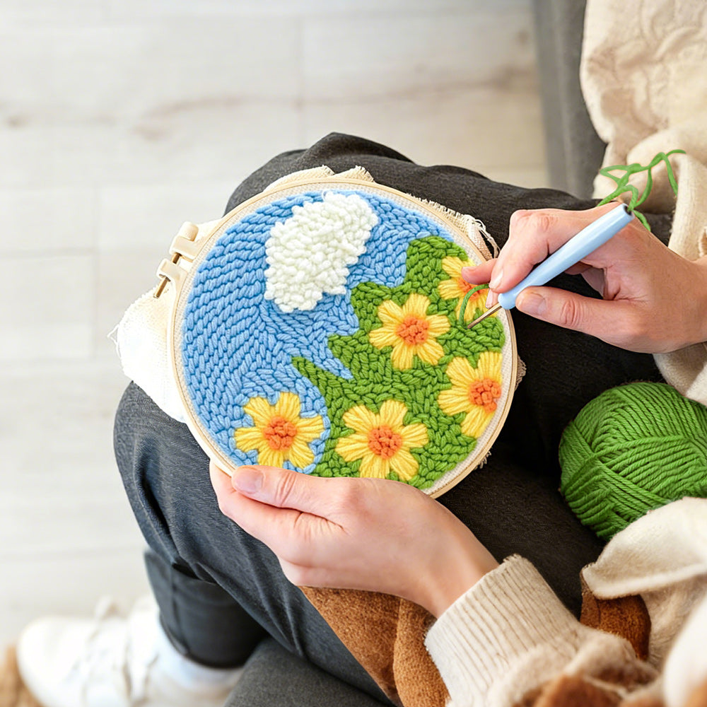 Creating handmade yellow flowers under a cloud punch needle artwork
