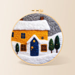 Yellow house and snowy ground needle felting kit for beginners with a round wooden frame