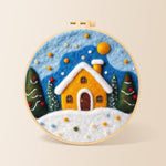 Yellow snowy cottage at christmas needle felting kit for beginners with a round wooden frame