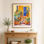 Finished yellow steps with cactus pots and blue door cross stitch artwork displayed as home decor