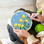 Creating handmade yellow tulips under starry sky punch needle artwork